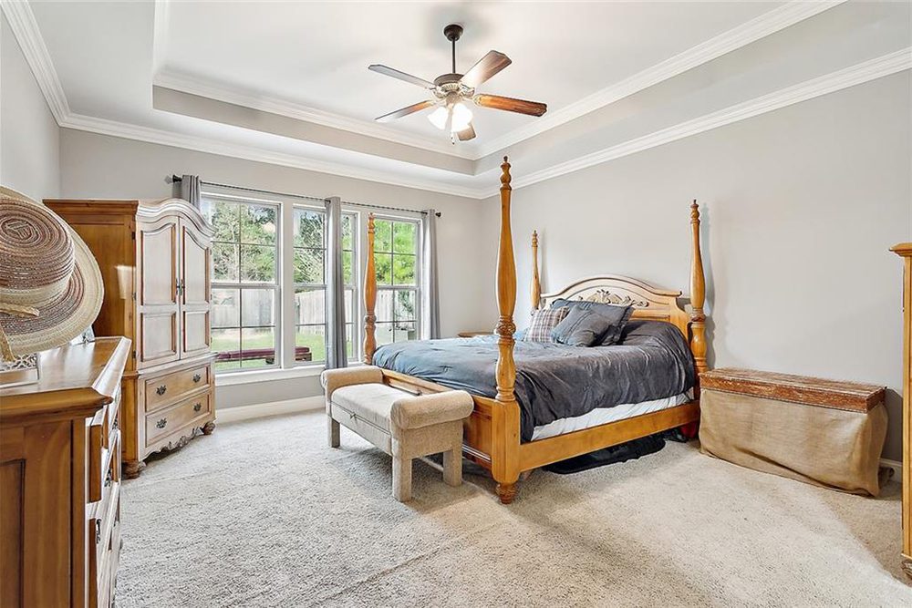 10-Primary Bedroom -3033 Lost Lake With serene backyard views and a refined yet inviting aesthetic, this bedroom is the perfect retreat for relaxation.