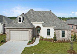 1024 Cypress Crossing beautifully designed front exterior of this new construction home is both stucco and brick. The roof is composed of custom architectural shingles and has a pleasing contour. The yard on this new construction home is fully landscaped.