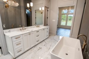 Master bathroom has a large double vanity with tons of cabinet space and a nice marble countertop. The master bathroom also features custom lighting.