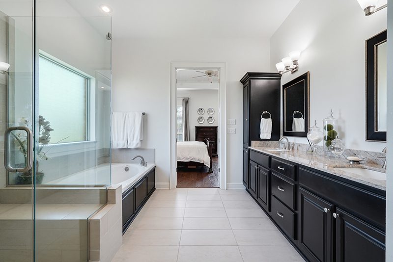 A master bathroom overview that also features a picture window above the soaking tub.