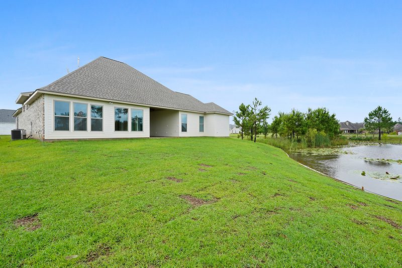 Rearview of this exterior home found close to New Orleans. The house sits on a lot that looks over the private pond.