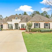 A nice externded drive and plush landscaping.