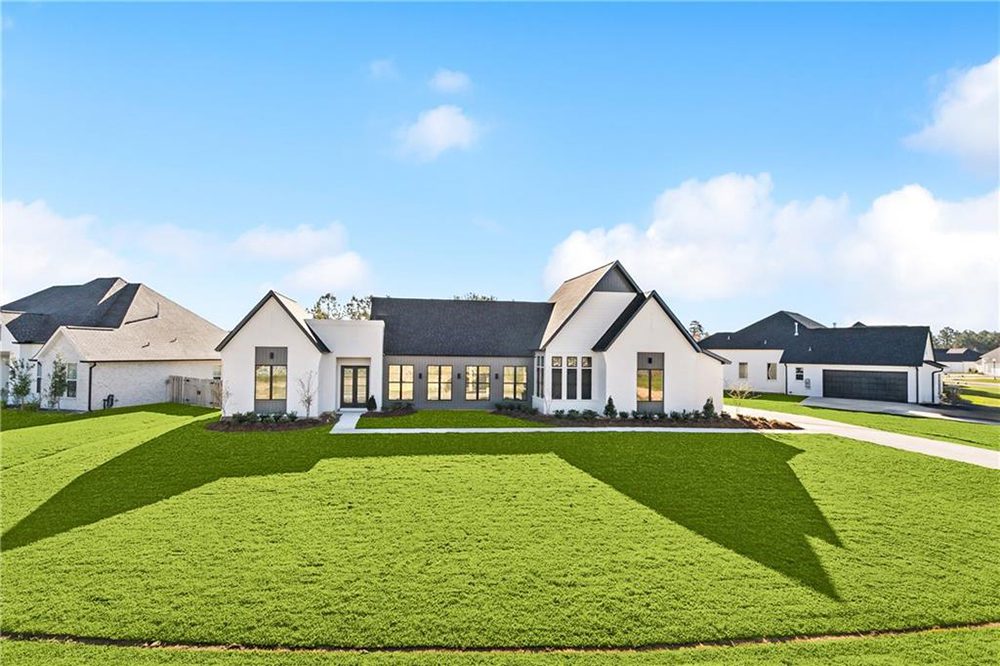 2- exterior 1174 Audubon Pkwy The blend of dark accents and bright stucco creates striking contrast, enhancing its curb appeal and contemporary style.