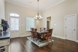 This home has hardwood floors. This dining area has a nice chandelier.