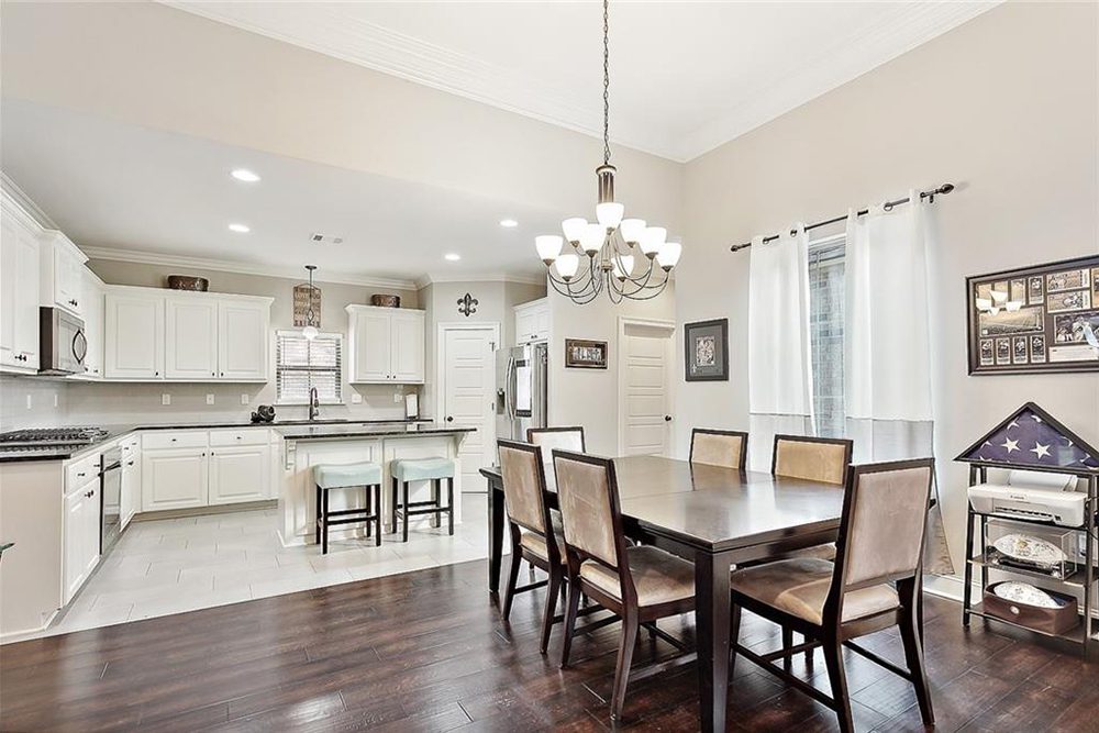 3-3033 Lost Lake Dining Area Stainless steel appliances, including a gas range and double-door refrigerator, add a modern touch to the classic design.