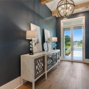 The foyer is a rich dark color yet is open and bright from the natural lighting.