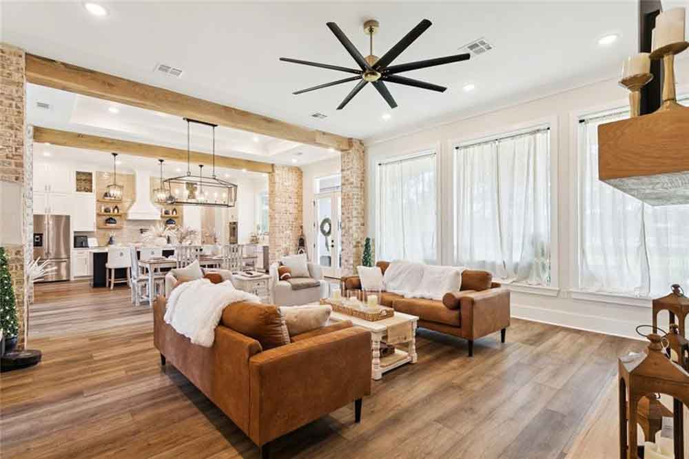 Open-concept living and dining area featuring tall windows that flood the space with natural light.