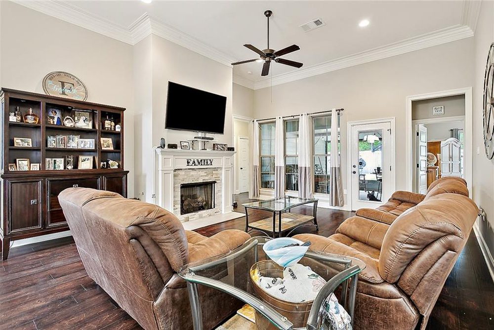 8-3033 Lost Lake Custom Built Ins Crown molding and a statement ceiling fan complete the sophisticated yet comfortable aesthetic, making this space perfect for relaxing and gathering with loved ones.
