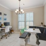 The breakfast area in this open floor plan is used for an eating area and a home office area.