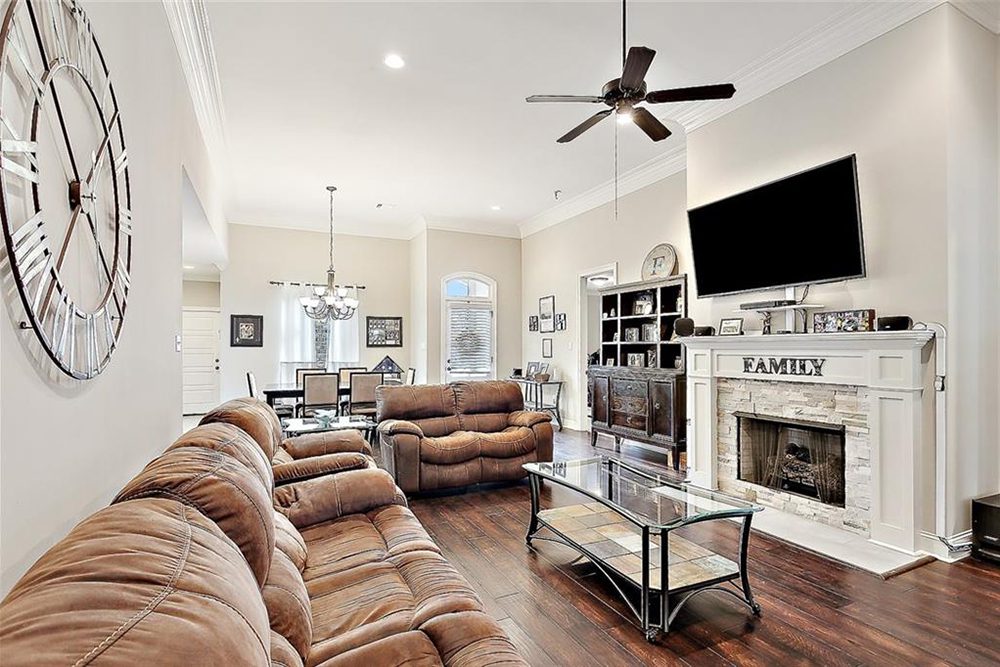 9-3033 Lost Lake Welcoming Home The open dining area in the background features a chic chandelier and natural light streaming in through large windows, seamlessly blending the living and dining areas into one inviting and functional space.